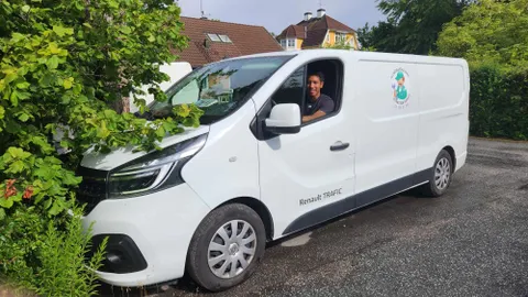 Servicebil från Allmänna Rörjouren med tekniker, parkerad i ett villaområde i Stockholm